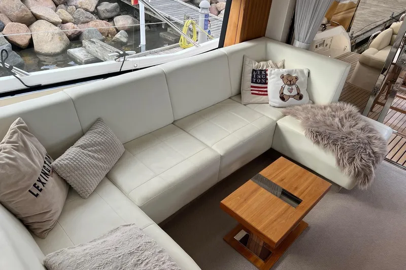  Yacht Photos Pics Luxurious Sunseeker Manhattan 53 yacht interior with plush white seating and decorative pillows, 2012 model.