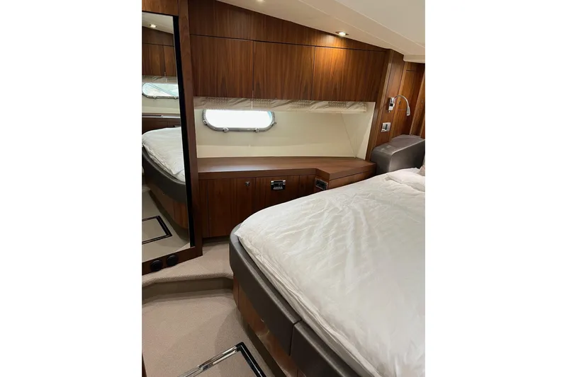  Yacht Photos Pics Luxurious cabin interior of 2012 Sunseeker Manhattan 53 yacht with wood paneling.