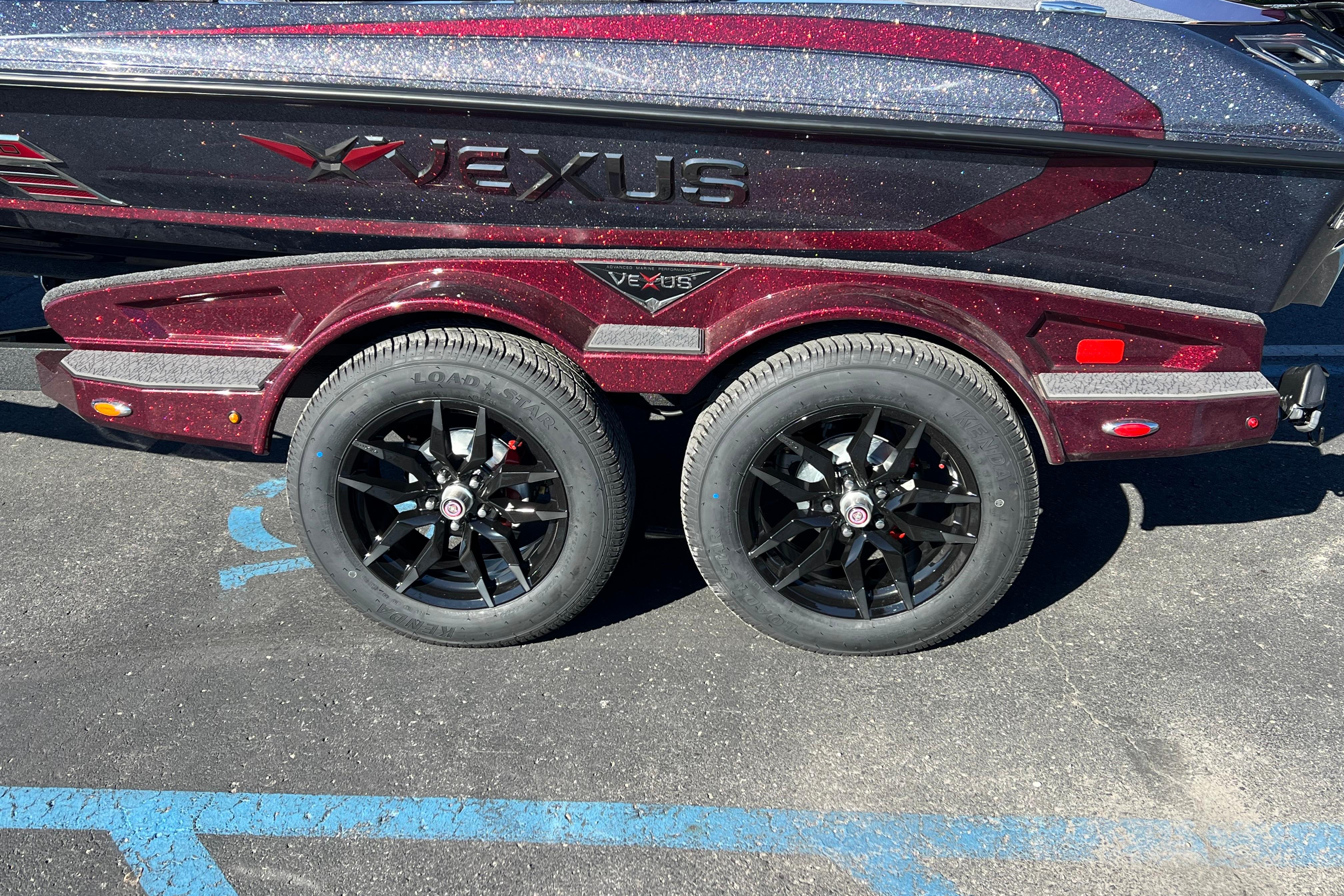 2026 Vexus VXS20 boat trailer with black alloy wheels and sparkling maroon finish.