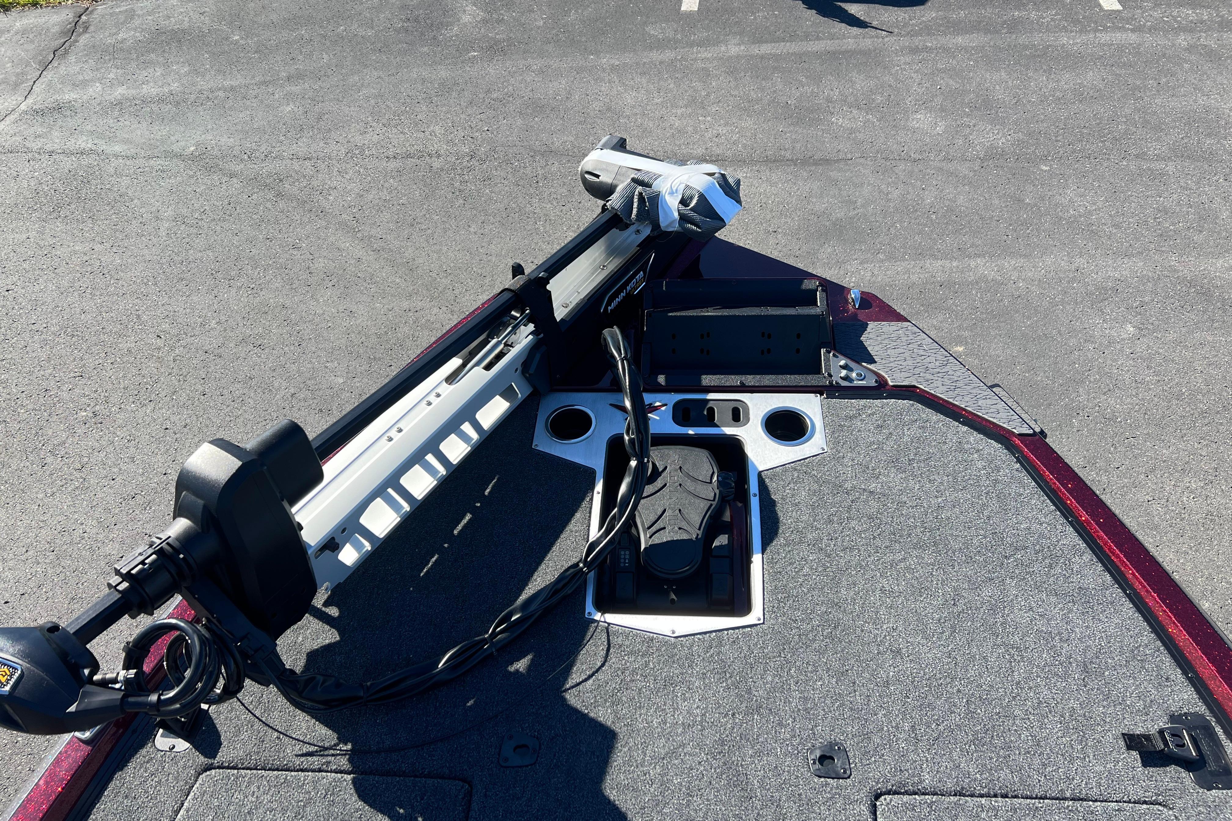 2026 Vexus VXS20 boat deck with mounted trolling motor, parked on asphalt.