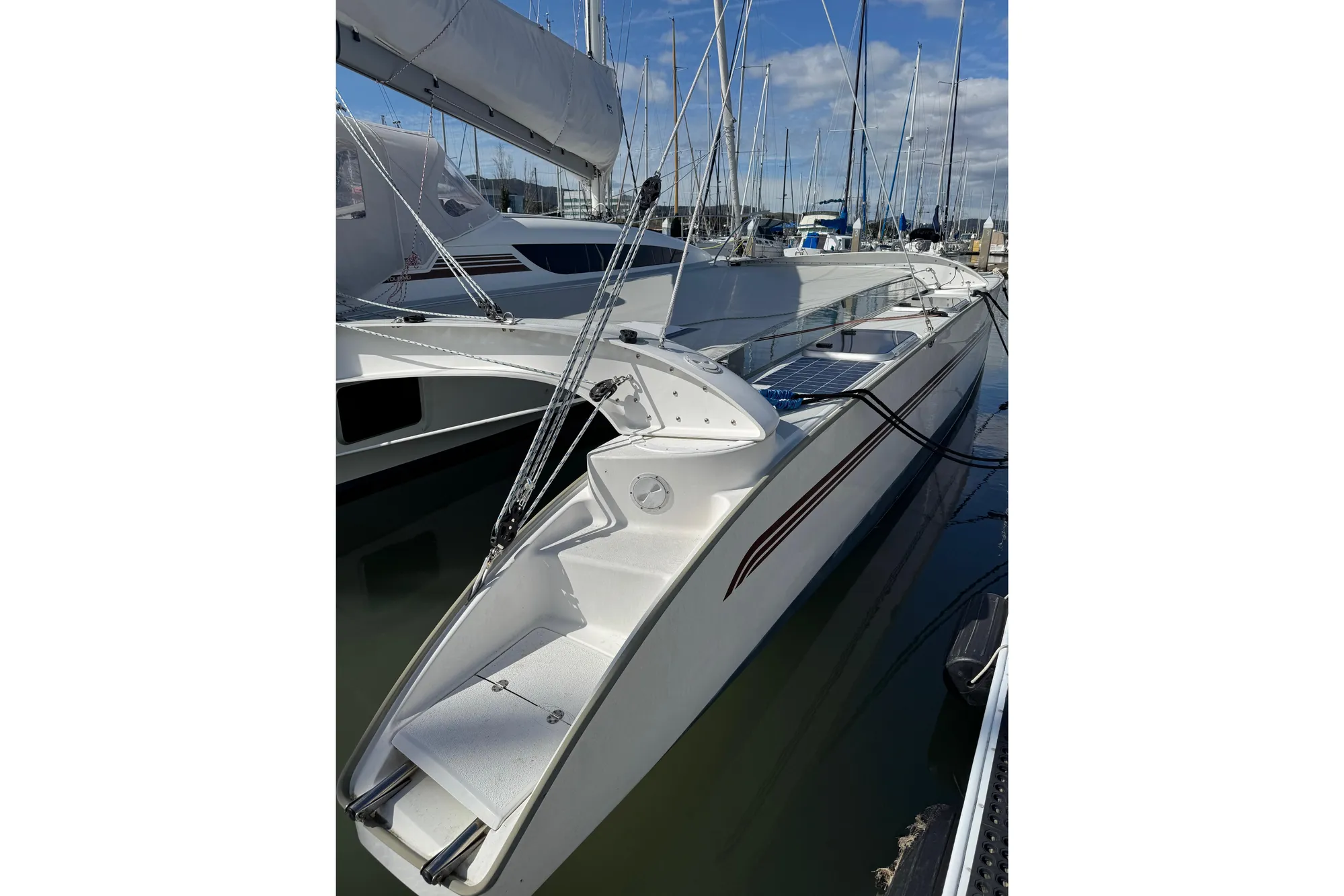 2016 Dragonfly 32 sailboat docked in marina, featuring sleek design and modern rigging.