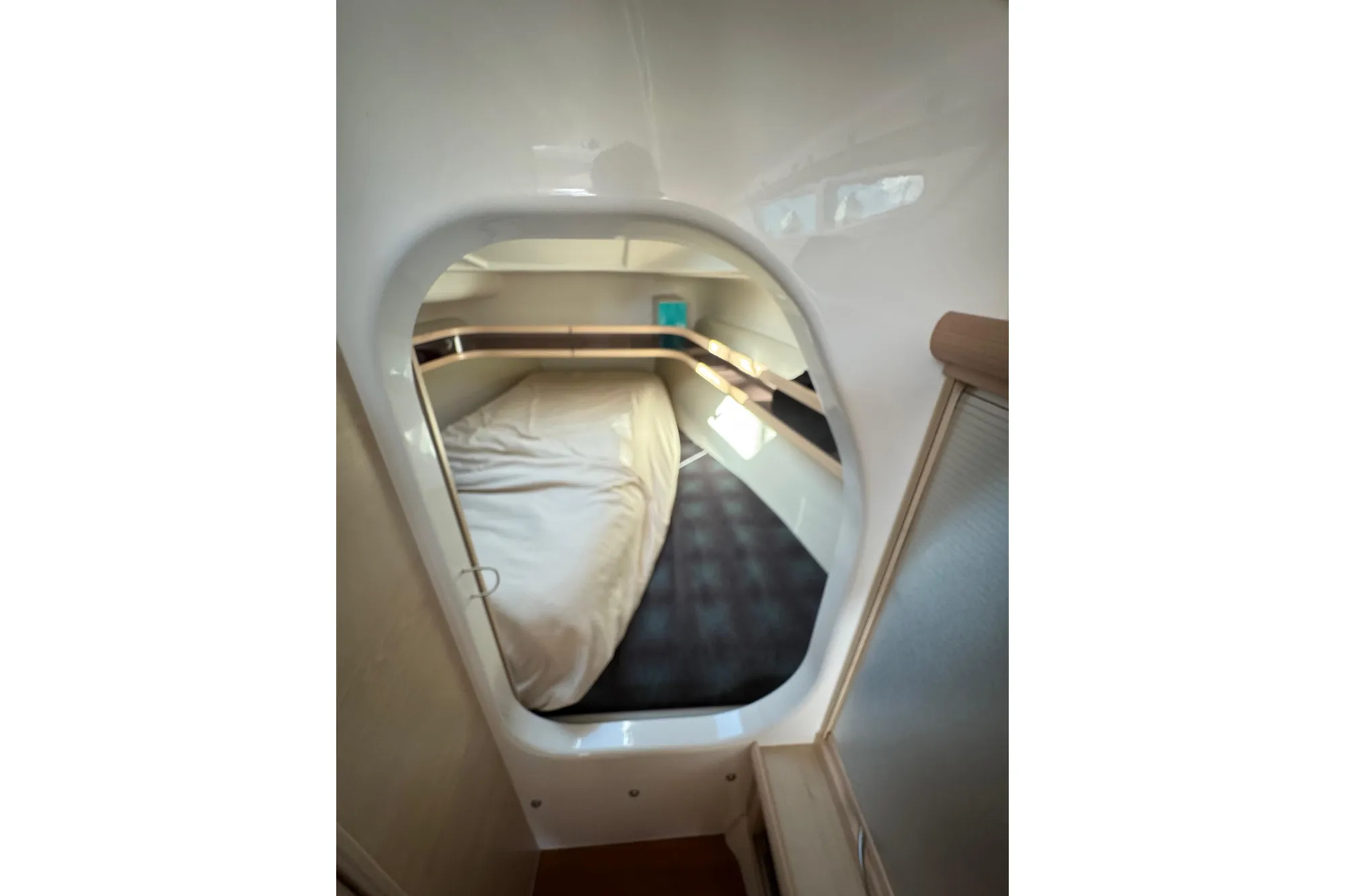 Cozy cabin interior of 2016 Dragonfly 32 sailboat with bed and storage.