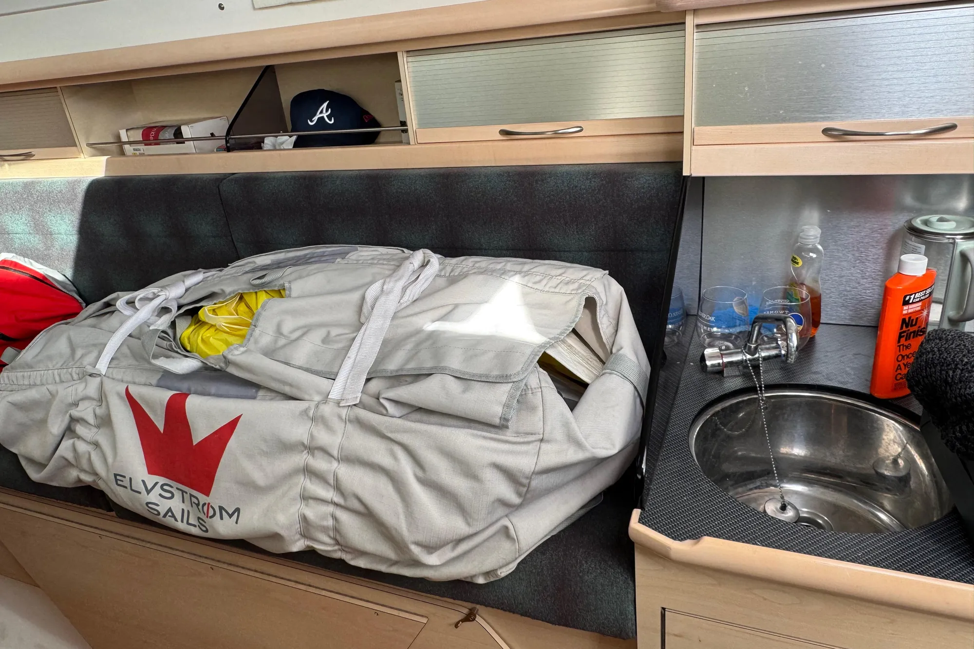Interior of a 2016 Dragonfly 32 sailboat with Elvstrøm sails and compact sink area.