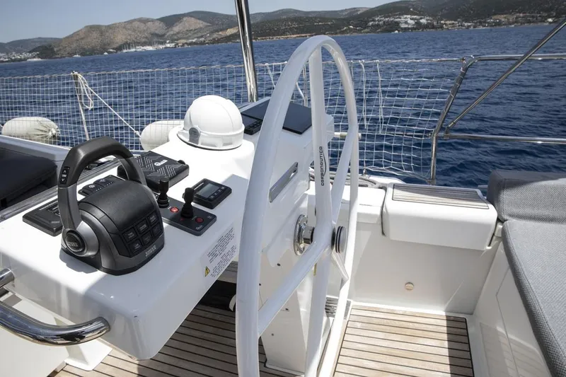  Yacht Photos Pics Cockpit of 2020 Jeanneau 64 yacht with steering wheel and controls, sailing on open sea.