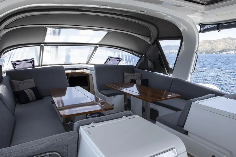  Yacht Photos Pics Luxurious interior of 2020 Jeanneau 64 yacht with elegant seating and ocean view.