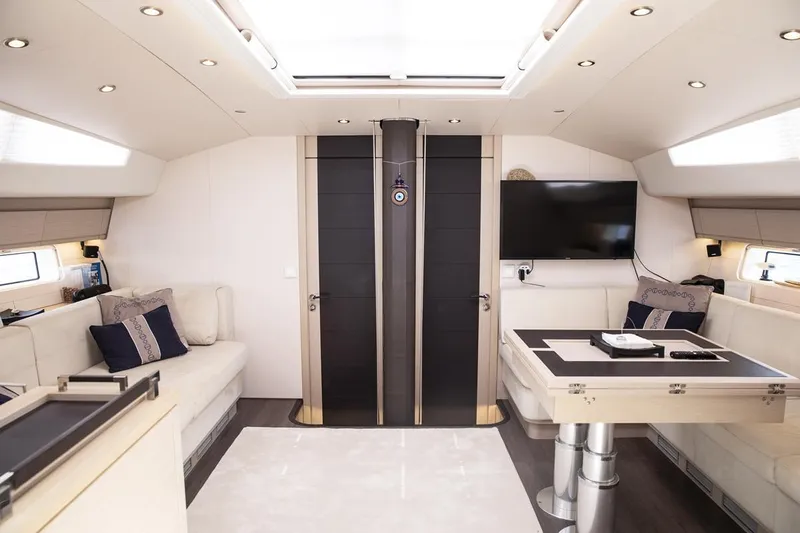  Yacht Photos Pics Luxurious interior of 2020 Jeanneau 64 yacht with modern furnishings and sleek design.