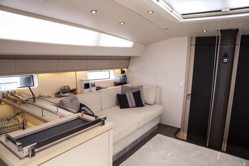  Yacht Photos Pics Luxurious interior of 2020 Jeanneau 64 yacht with modern seating and elegant design.