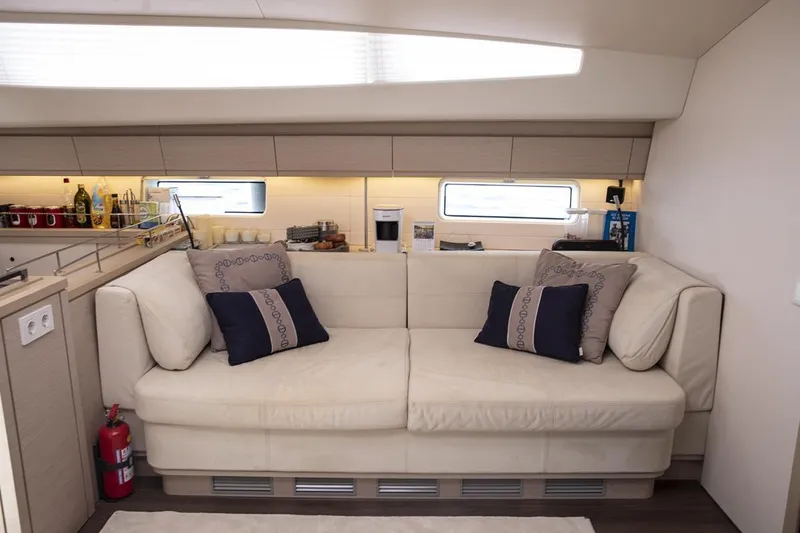 Yacht Photos Pics Luxurious interior of 2020 Jeanneau 64 yacht with elegant beige sofa and modern decor.