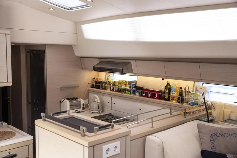  Yacht Photos Pics Luxurious Jeanneau 64 yacht kitchen interior, featuring modern appliances and sleek design, 2020 model.