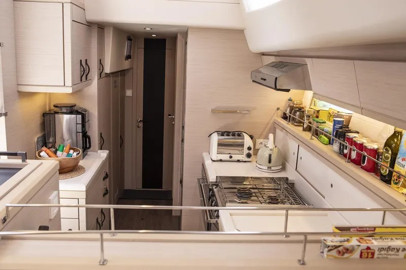  Yacht Photos Pics Modern kitchen interior of 2020 Jeanneau 64 yacht with appliances and storage.