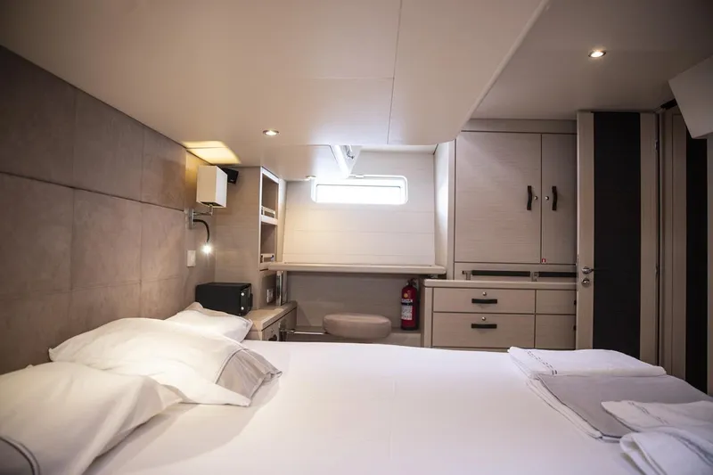  Yacht Photos Pics Luxurious cabin interior of 2020 Jeanneau 64 yacht with modern furnishings and cozy bed.