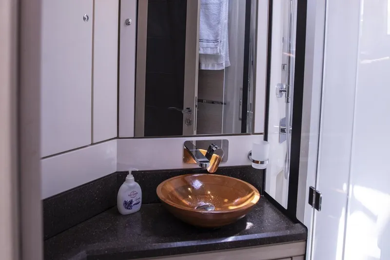  Yacht Photos Pics Luxurious bathroom on a 2020 Jeanneau 64 yacht with elegant sink and modern fixtures.
