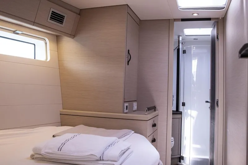  Yacht Photos Pics Luxurious interior cabin of 2020 Jeanneau 64 yacht with modern design and ensuite bathroom.