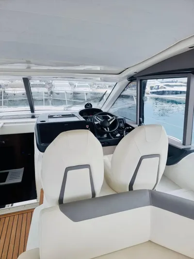  Yacht Photos Pics Interior of 2021 Princess V50 Open yacht with modern helm and seating.