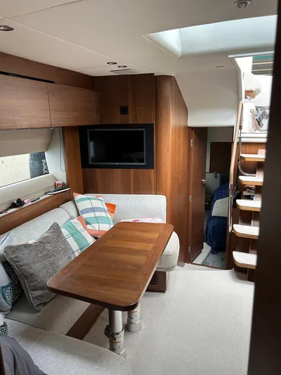  Yacht Photos Pics Interior of 2021 Princess V50 Open yacht with cozy seating and wooden accents.