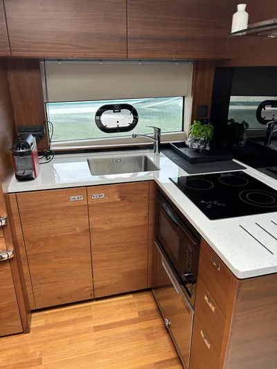  Yacht Photos Pics Modern kitchen in 2021 Princess V50 Open yacht with sleek wood cabinetry and appliances.