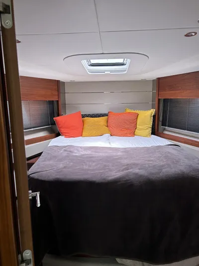  Yacht Photos Pics Luxurious bedroom interior of 2021 Princess V50 Open yacht with colorful pillows.