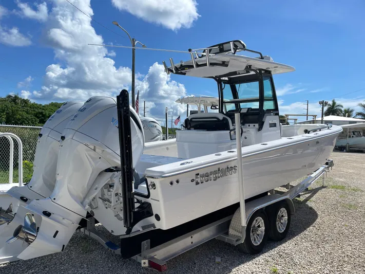 #339 White Yacht Photos Pics 2023 Everglades 273CC boat on trailer, featuring dual engines, under a clear blue sky.