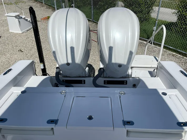 #339 White Yacht Photos Pics 2023 Everglades 273CC boat with dual outboard engines, parked on gravel.