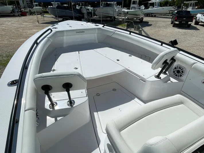 #339 White Yacht Photos Pics 2023 Everglades 273CC boat interior with seating and steering wheel, in a marina setting.