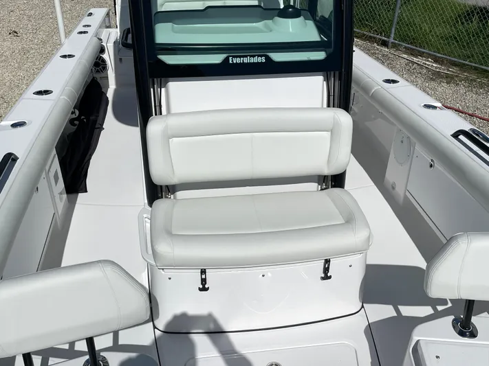#339 White Yacht Photos Pics 2023 Everglades 273CC boat interior with white seating and console.
