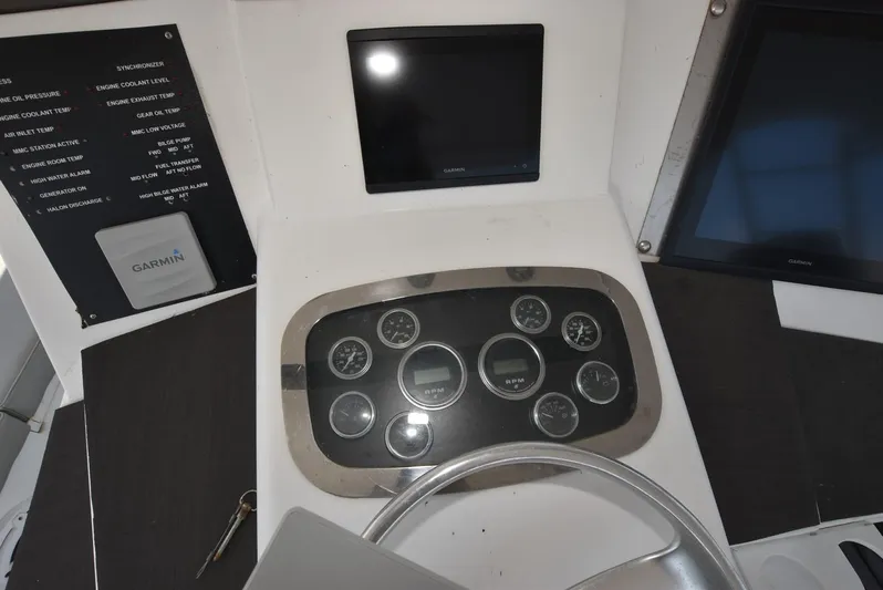 For Reel Yacht Photos Pics 1997 Viking 50 Convertible dashboard with gauges and Garmin navigation system.