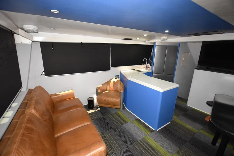 For Reel Yacht Photos Pics Interior of 1997 Viking 50 Convertible yacht with leather seating and modern kitchenette.