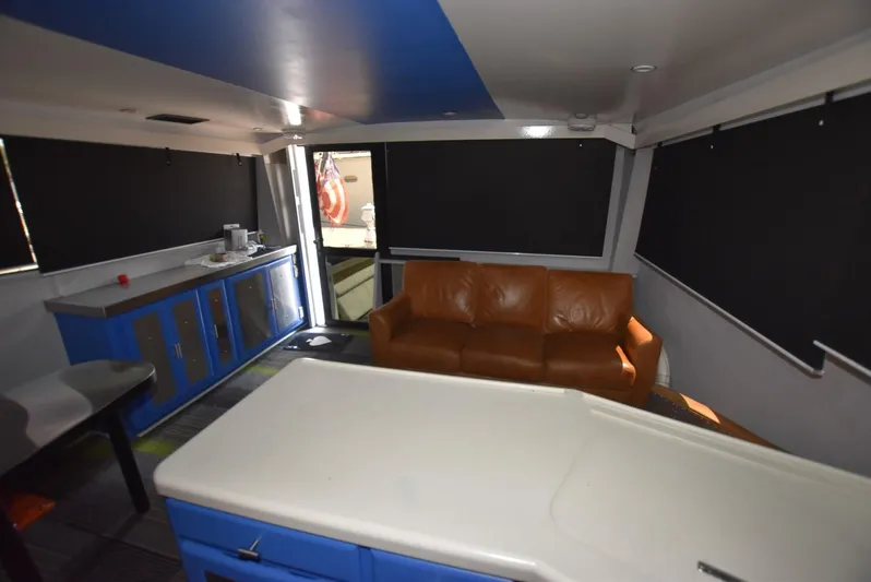 For Reel Yacht Photos Pics Interior of 1997 Viking 50 Convertible yacht with leather sofa and blue cabinetry.