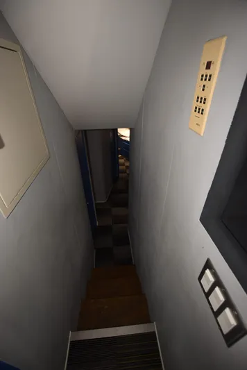 For Reel Yacht Photos Pics Narrow hallway inside 1997 Viking 50 Convertible yacht with control panel on wall.