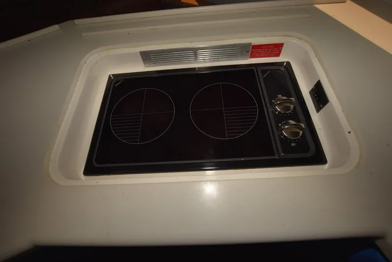 For Reel Yacht Photos Pics 1997 Viking 50 Convertible boat stove with dual burners in a compact kitchen setup.