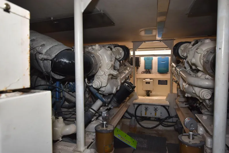 For Reel Yacht Photos Pics Engine room of a 1997 Viking 50 Convertible yacht, showcasing dual engines and mechanical components.