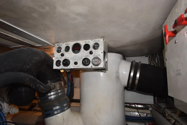 For Reel Yacht Photos Pics Engine room of 1997 Viking 50 Convertible yacht with control panel and piping.