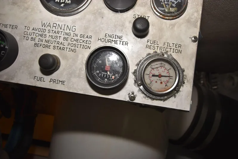 For Reel Yacht Photos Pics Control panel of a 1997 Viking 50 Convertible boat with gauges and warning labels.