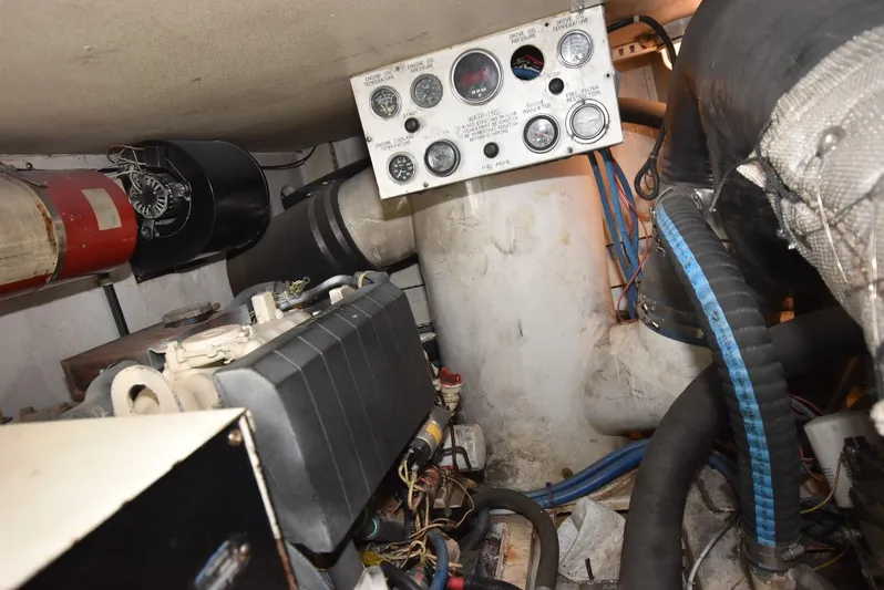 For Reel Yacht Photos Pics Engine room of a 1997 Viking 50 Convertible boat, featuring gauges and mechanical components.