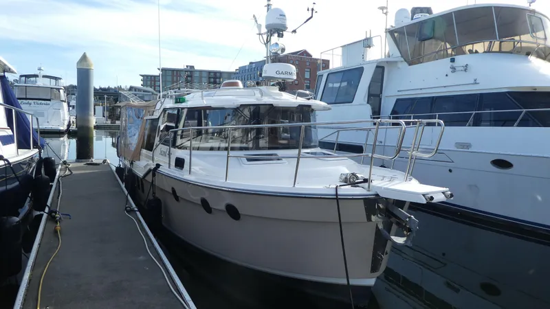 Second Act Yacht Photos Pics 2021 Ranger Tugs R-29 S docked at marina, surrounded by other boats.