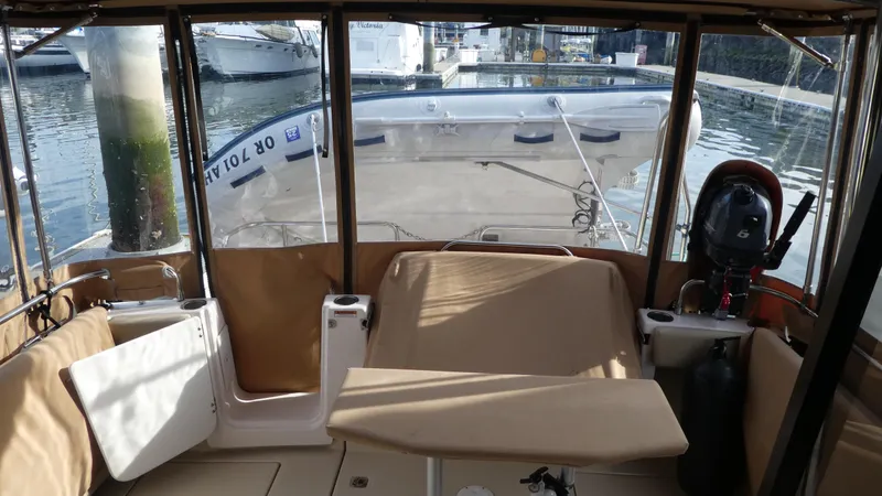 Second Act Yacht Photos Pics Interior view of 2021 Ranger Tugs R-29 S boat with seating and water backdrop.