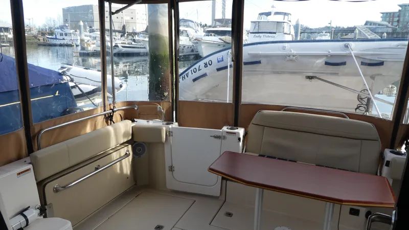 Second Act Yacht Photos Pics 2021 Ranger Tugs R-29 S interior with seating and table, docked at marina.
