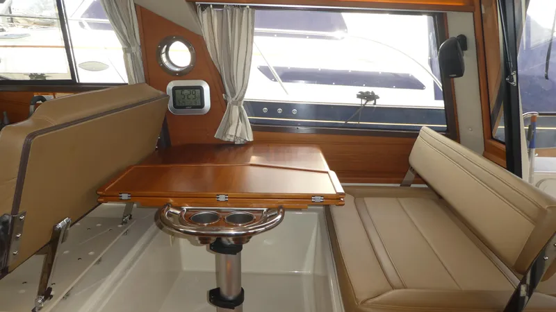 Second Act Yacht Photos Pics Interior of 2021 Ranger Tugs R-29 S with seating and wooden table.