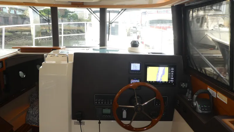Second Act Yacht Photos Pics Interior helm of 2021 Ranger Tugs R-29 S with navigation equipment and steering wheel.