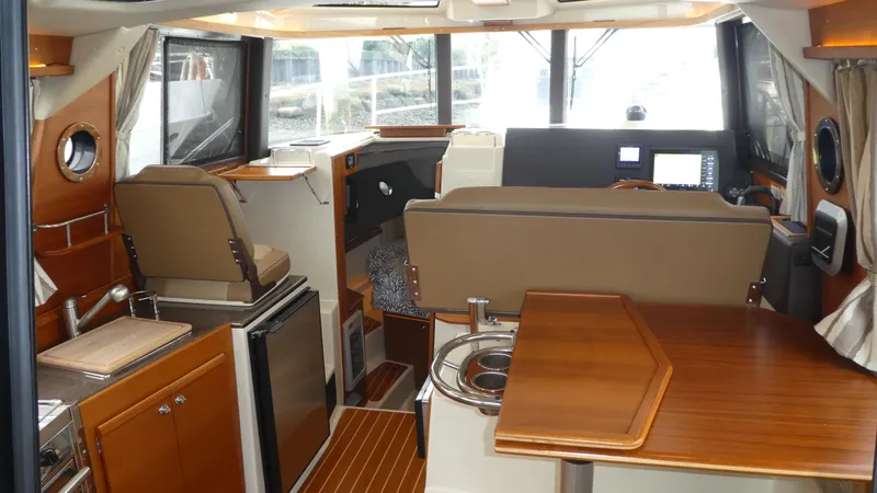 Second Act Yacht Photos Pics 2021 Ranger Tugs R-29 S interior with modern kitchen and seating area.