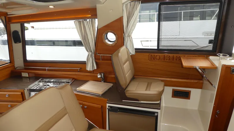 Second Act Yacht Photos Pics Interior of 2021 Ranger Tugs R-29 S, featuring wood accents and seating.