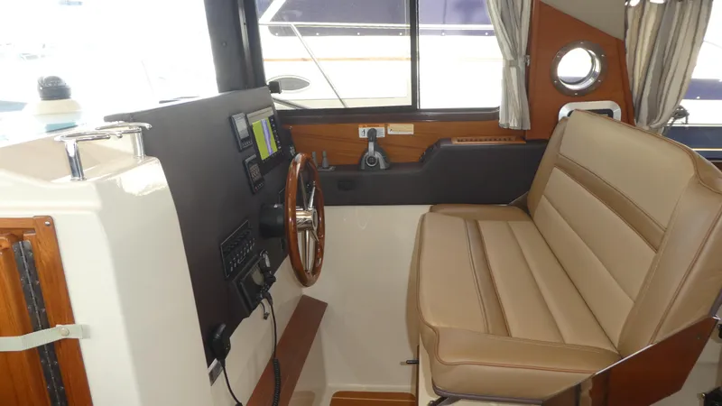 Second Act Yacht Photos Pics 2021 Ranger Tugs R-29 S helm with leather seating and navigation controls.