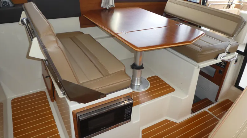 Second Act Yacht Photos Pics 2021 Ranger Tugs R-29 S interior with dining area and wood accents.