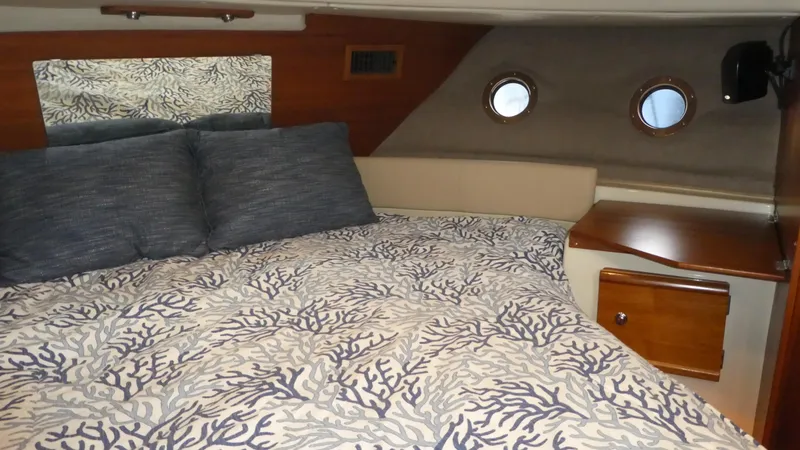 Second Act Yacht Photos Pics Cozy bedroom interior of 2021 Ranger Tugs R-29 S with nautical-themed bedding.
