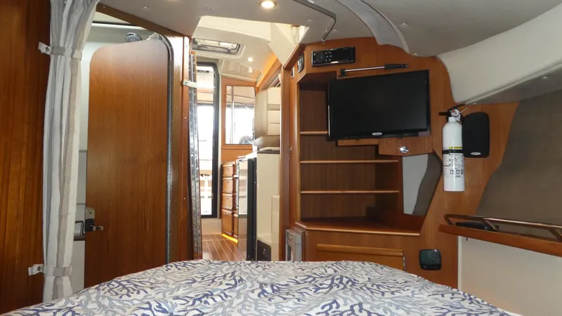 Second Act Yacht Photos Pics Interior of 2021 Ranger Tugs R-29 S, featuring cozy cabin with TV and wooden accents.