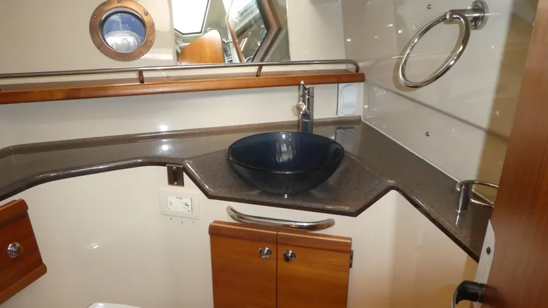 Second Act Yacht Photos Pics 2021 Ranger Tugs R-29 S bathroom with modern sink and wooden cabinetry.