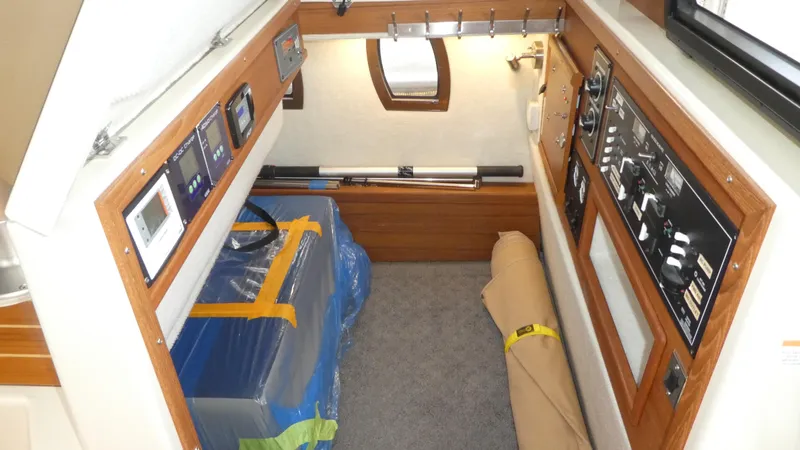 Second Act Yacht Photos Pics 2021 Ranger Tugs R-29 S interior cabin with control panels and storage area.