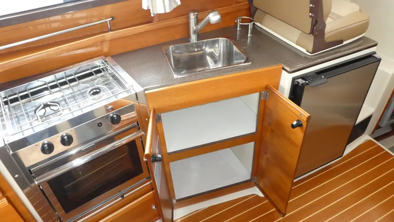 Second Act Yacht Photos Pics 2021 Ranger Tugs R-29 S galley with stove, sink, and refrigerator.