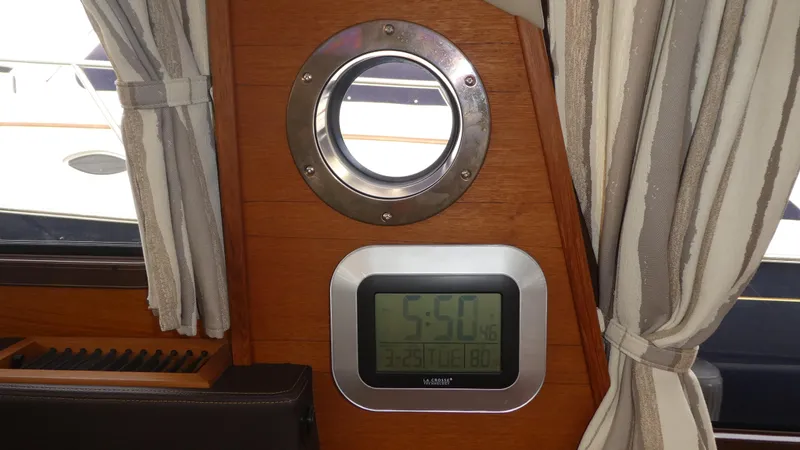 Second Act Yacht Photos Pics Porthole and digital clock inside 2021 Ranger Tugs R-29 S boat cabin.
