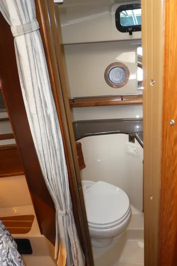 Second Act Yacht Photos Pics 2021 Ranger Tugs R-29 S boat interior bathroom with toilet and porthole window.